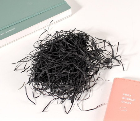 Paper shavings for cardboard boxes